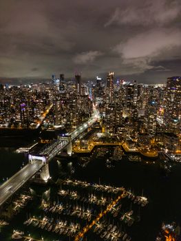 Stunning aerial night view of Vancouver's illuminated skyline and marina.