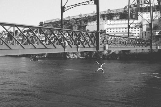 A man jumps off the iconic Dom Luís I Bridge into the Douro River in Porto, Portugal.