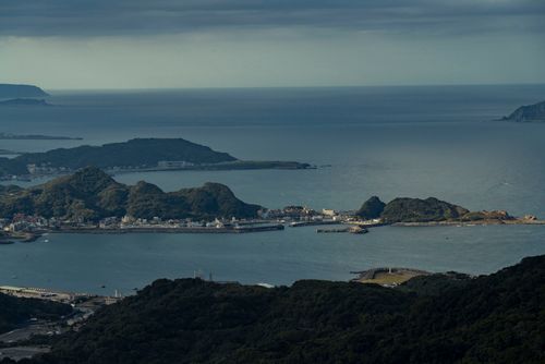 Free Aerial view of Taiwan's coastal landscape featuring lush green hills and ocean vistas. Stock Photo