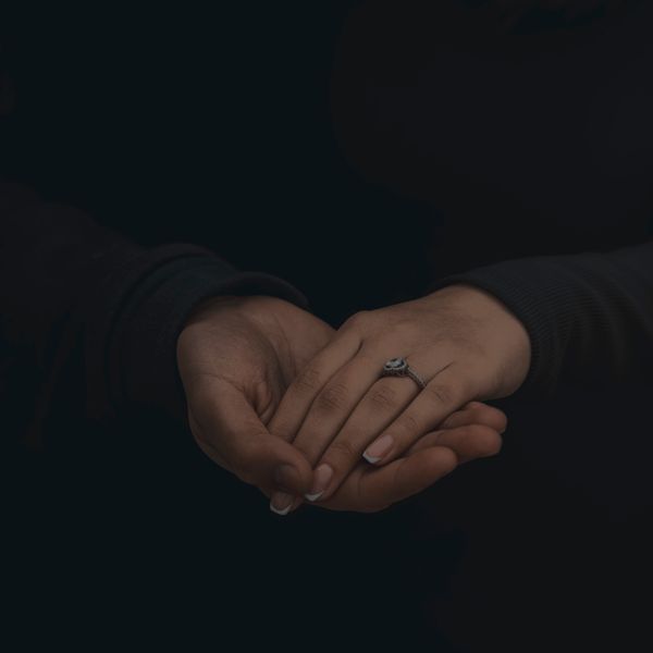 A couple holding hands in low light — photo by Rahib Hamidov on Pexels