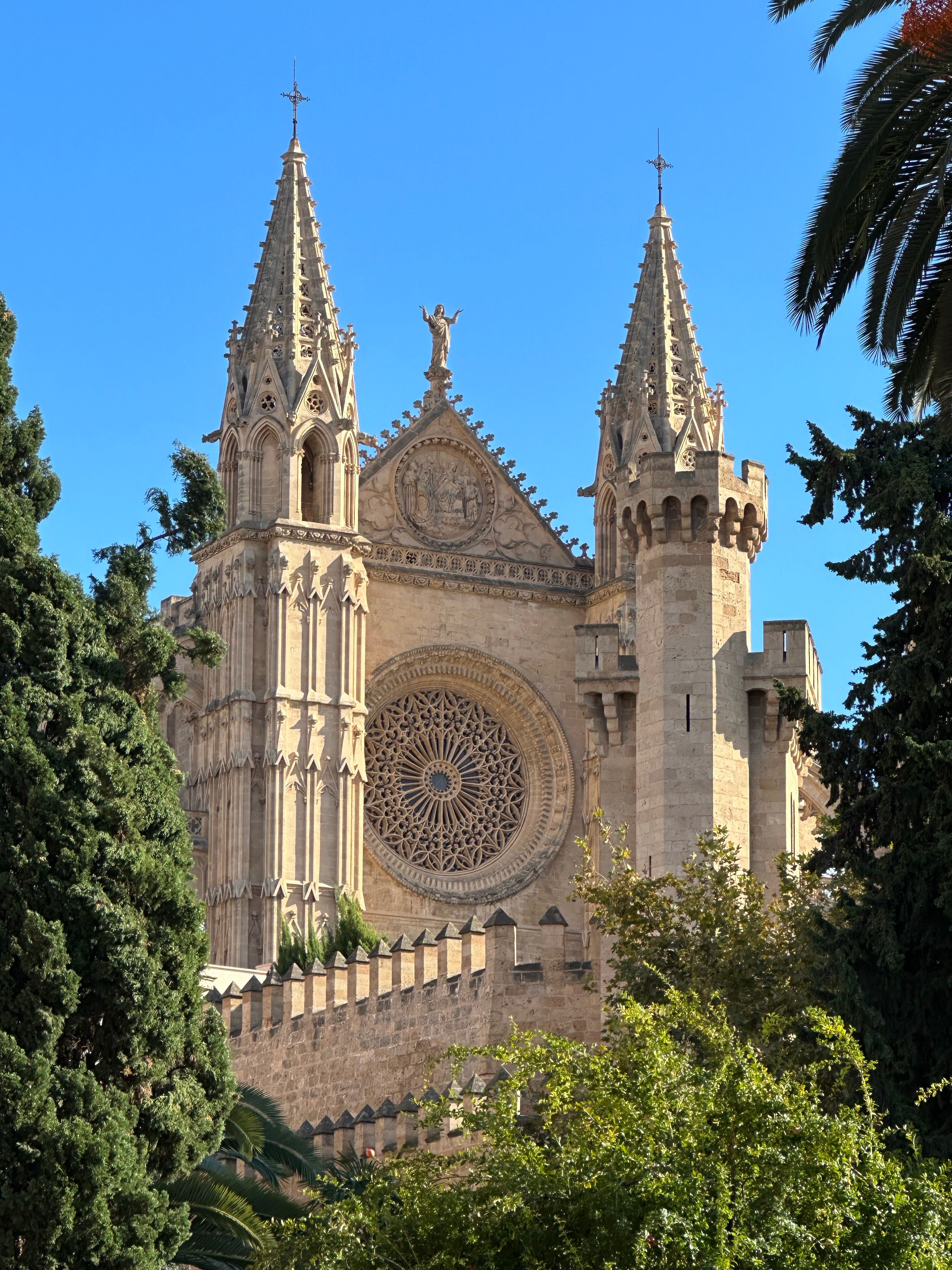 Gothic towers of Palma Cathedral La Seu rising against blue sky, Palma de Mallorca, Spain