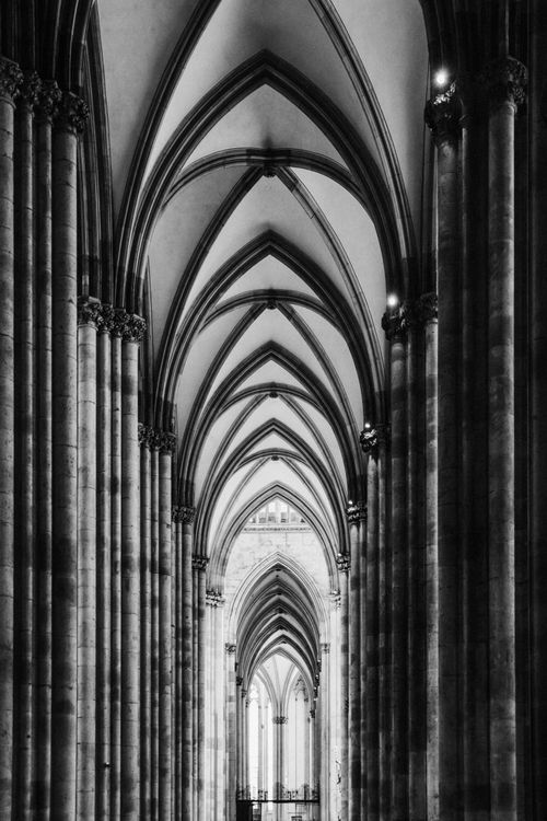 Free Black and white interior view of a Gothic cathedral with arches and colonnades. Stock Photo