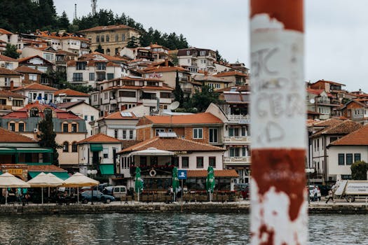 Picturesque waterfront town with red tile roofs and colorful buildings by the sea.