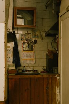 Warm and nostalgic kitchen interior featuring a rustic wooden counter and vintage decor.