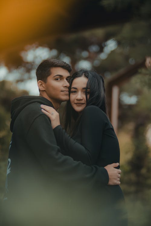 Free A Couple Standing Outside and Hugging  Stock Photo