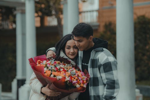 Embracing Couple with a Bouquet 