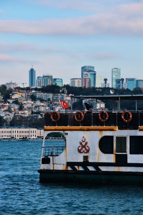 Free View of a ferry on the Bosphorus Strait with Istanbul's skyline in the background. Stock Photo