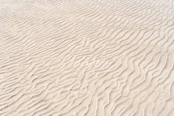 Rippled sand ridges catching low sunlight — Alejandro Henriquez on Pexels