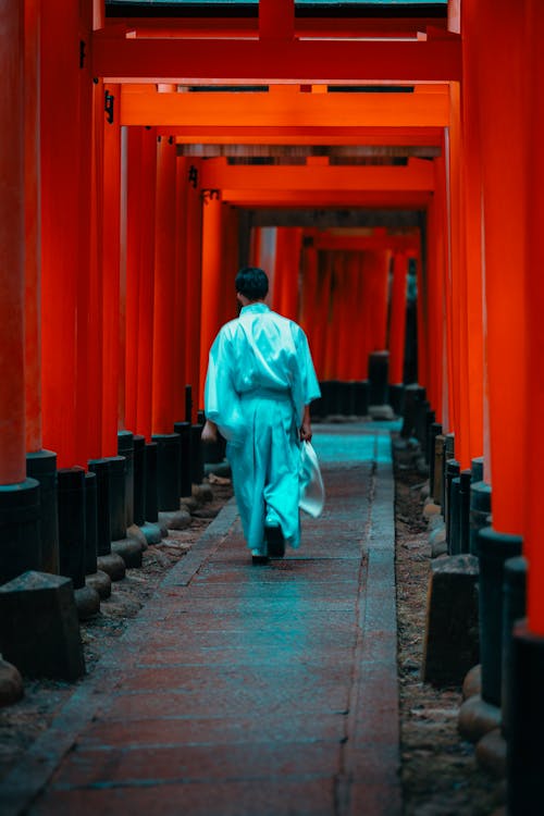 Man Walking on Pavement at Buddhist Temple