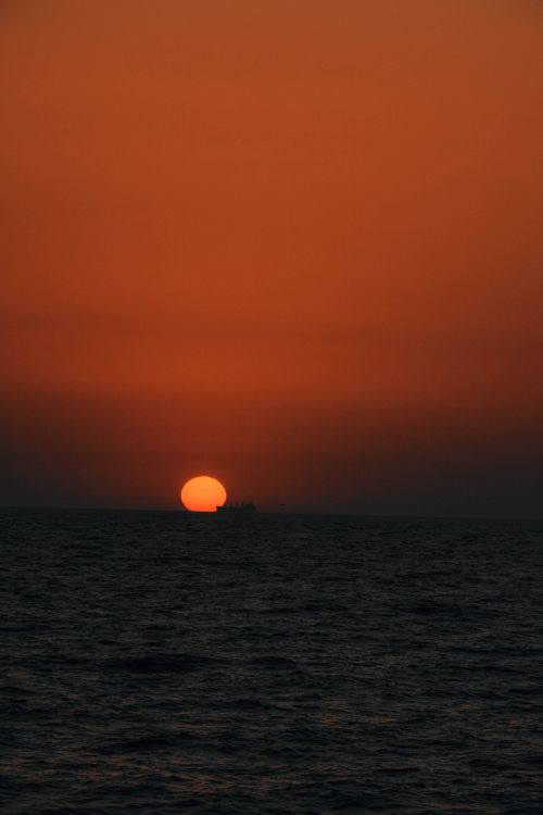 Free A serene view of the sunset over the Black Sea, creating a warm and tranquil atmosphere. Stock Photo