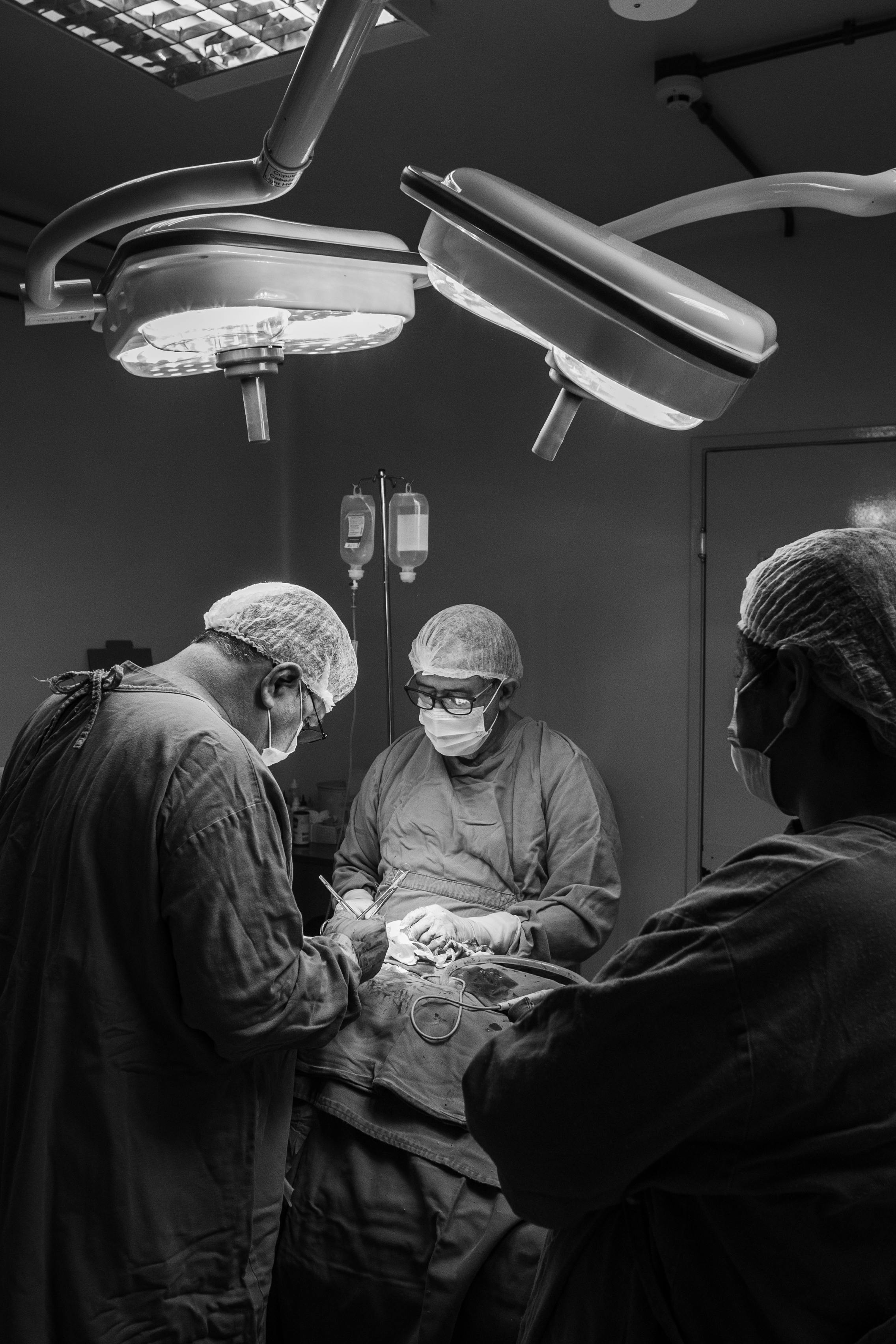 surgeons working in black and white