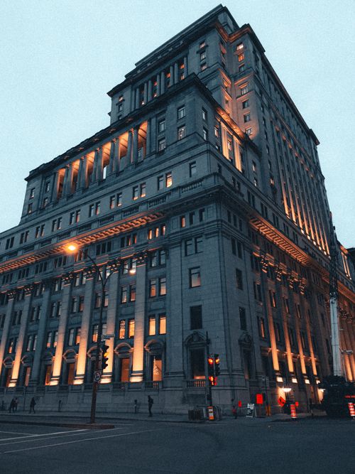 Free A majestic historic building beautifully illuminated against the twilight sky. Stock Photo