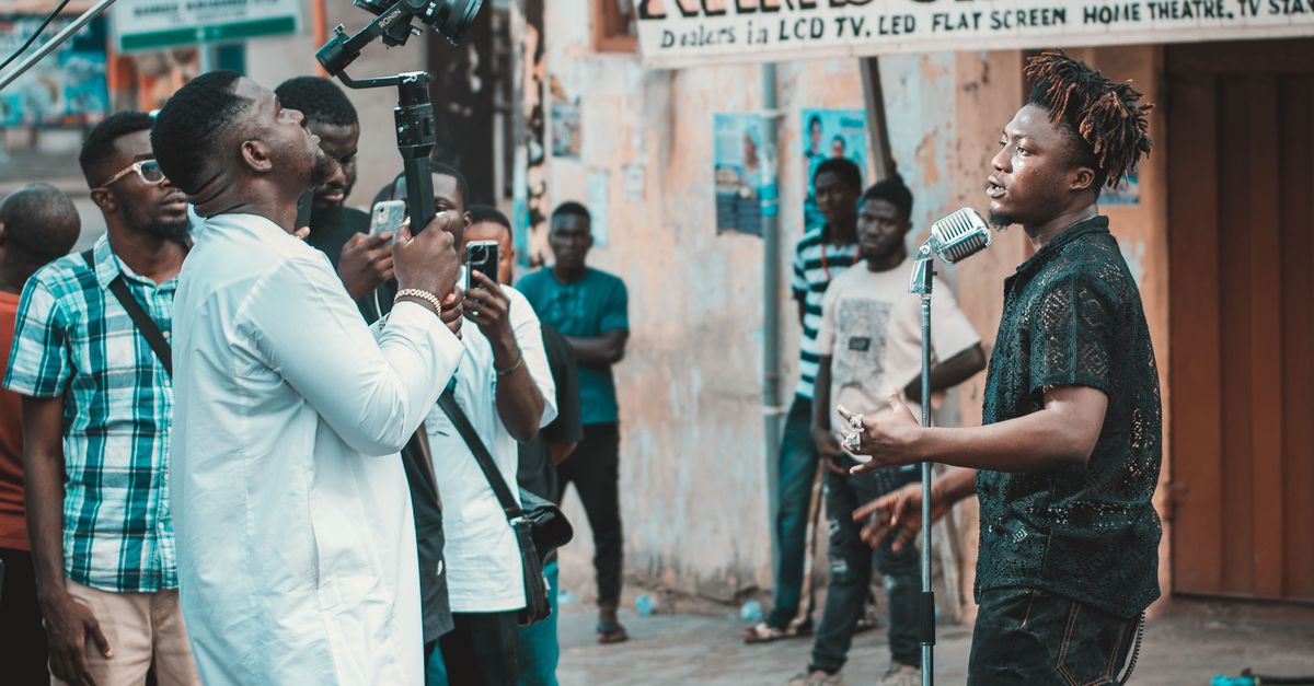 Singer Scene First Camera Camera Man Filming a Singer on a City Street · Free Stock Photo