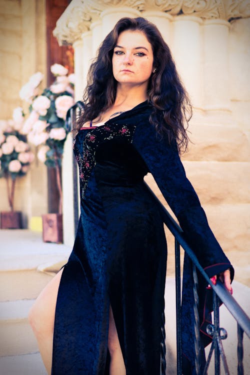 Woman in Black Dress Posing on Stairs