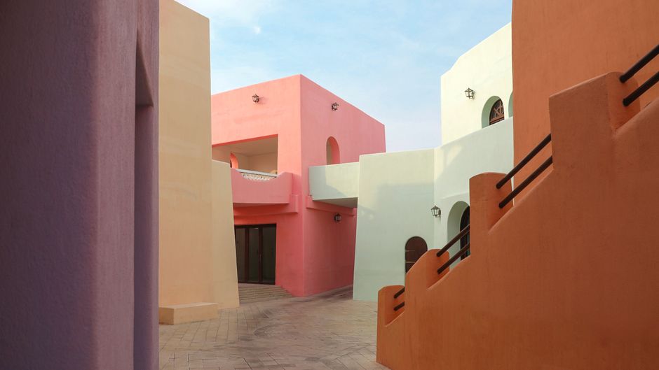Vibrant pastel-colored architecture in the Mina District of Doha, Qatar.