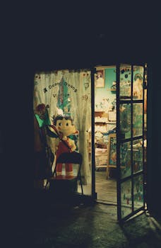 A cozy toy store entrance with illuminated glass door at night showcasing vintage toys and decor.