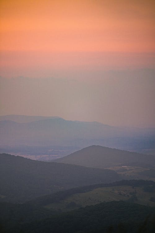 Aerial View of a Foggy Valley Among the Mountains