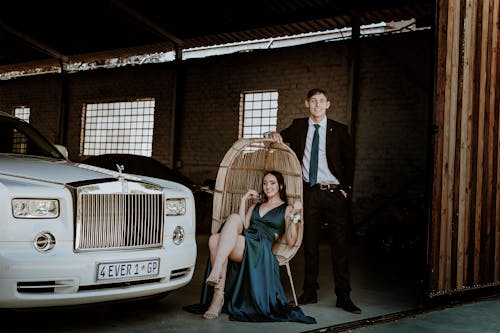 Elegant Couple Next to a White Rolls Royce 