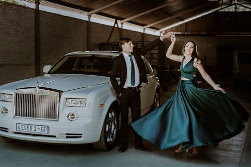 Elegant Couple in Front of a White Car 