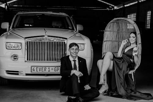 Elegant Man and Woman Posing by Rolls-Royce Phantom