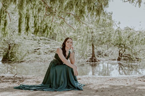 Elegant Woman by the Stream in a Park