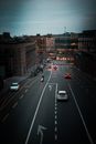High angle of cars and motorcyclists on city highway with bike lanes and cyclists in evening