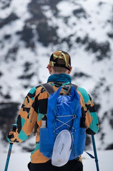 A lone hiker explores snowy landscapes in Tux, Tirol, showcasing vibrant sportswear.