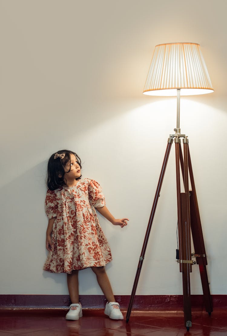 Little Girl Next To A Lamp 