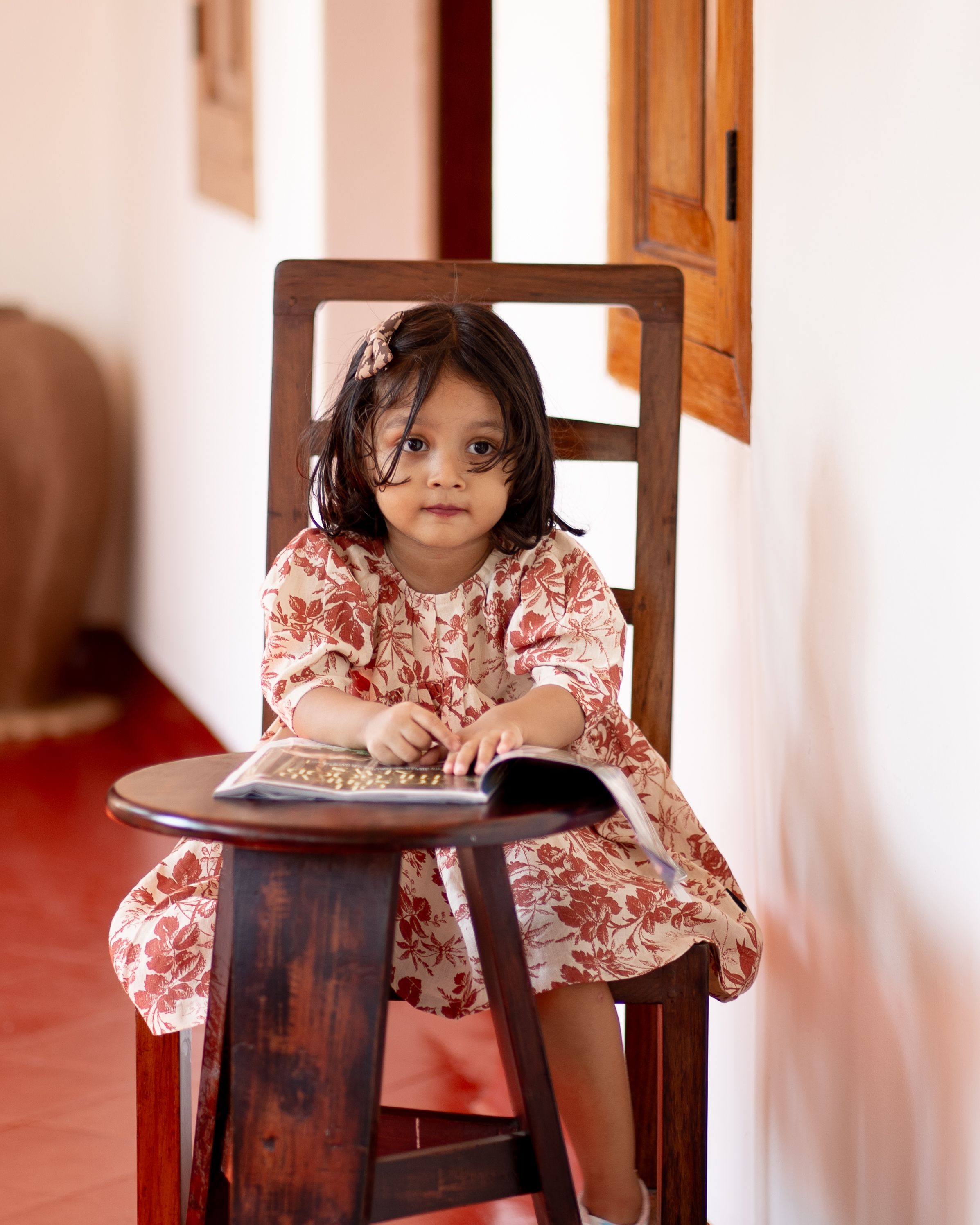 Little Girl Sitting on a Wooden Chair · Free Stock Photo
