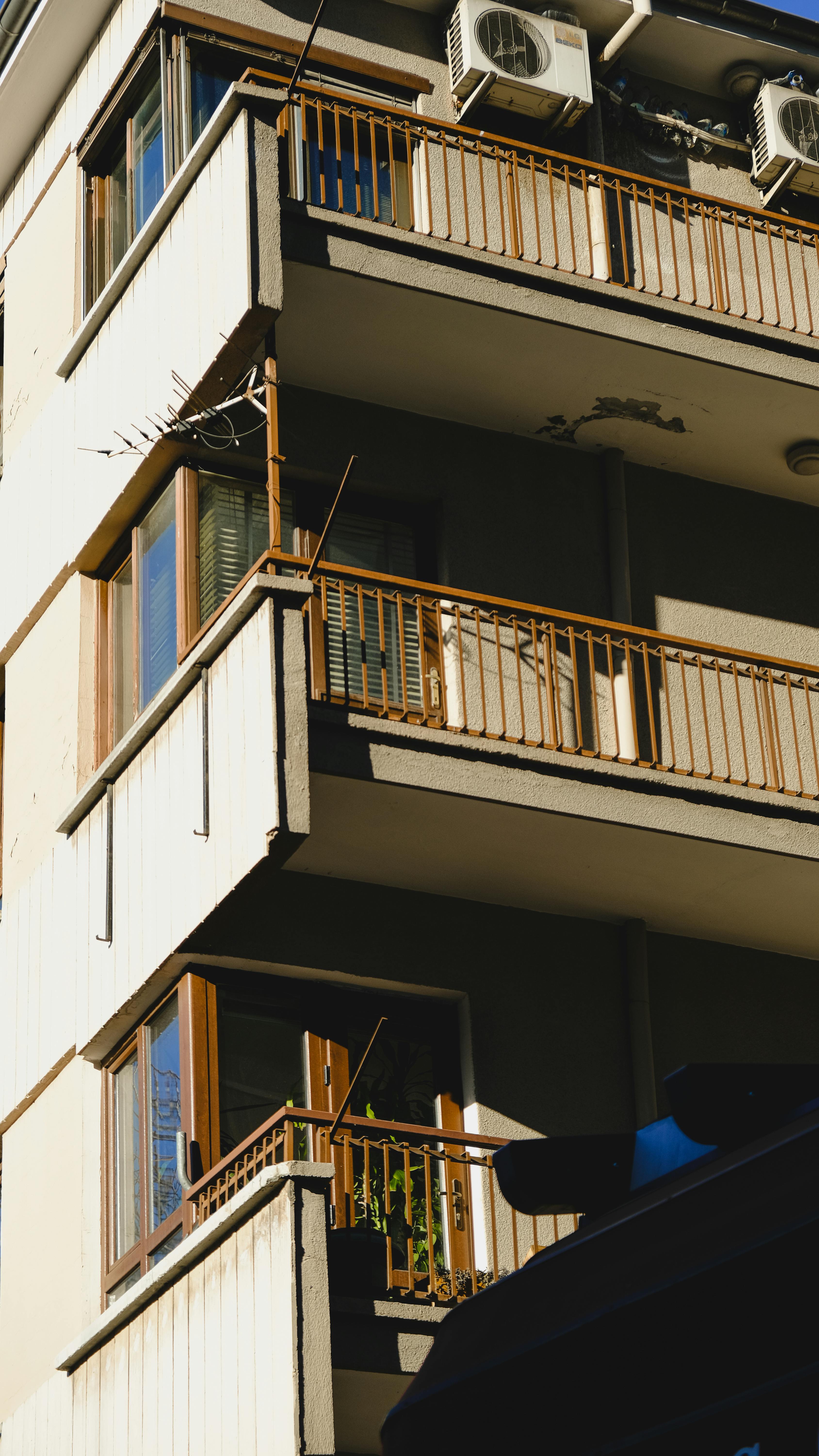 A sunlit facade of a residential building with balconies in Ankara, Turkey.