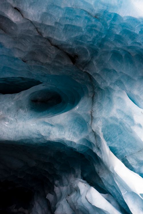 Free Explore mesmerizing ice patterns in an Alaskan glacier cave, capturing the essence of polar climates. Stock Photo