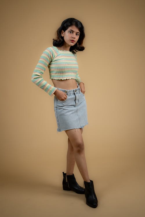 Young Model in a Sweater Crop Top and Denim Skirt