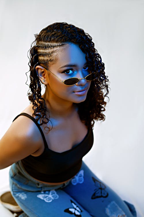Studio Shot of a Young Woman in a Trendy Outfit and Sunglasses