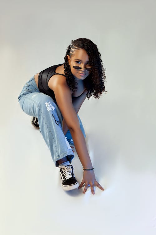 Studio Shot of a Young Woman in a Trendy Outfit and Sunglasses