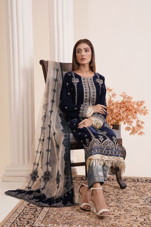 Free A young woman models a luxurious embroidered dress in a studio setting. Stock Photo