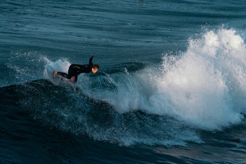 Man Surfing on the Sea Water