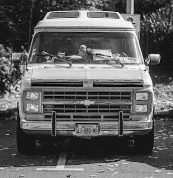 A retro Chevrolet van captured in a black and white photograph, showcasing its vintage design.