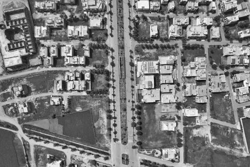 Free Drone shot of residential area in Gujranwala, Pakistan, capturing urban structure in black and white. Stock Photo