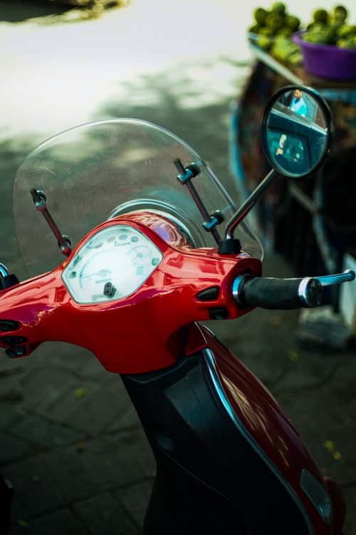 Free Detailed view of a red motor scooter handlebar with a speedometer in El Jadida, Morocco. Stock Photo