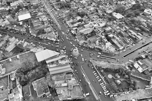 Drone Shot of Town and Traffic on Streets and Roundabout