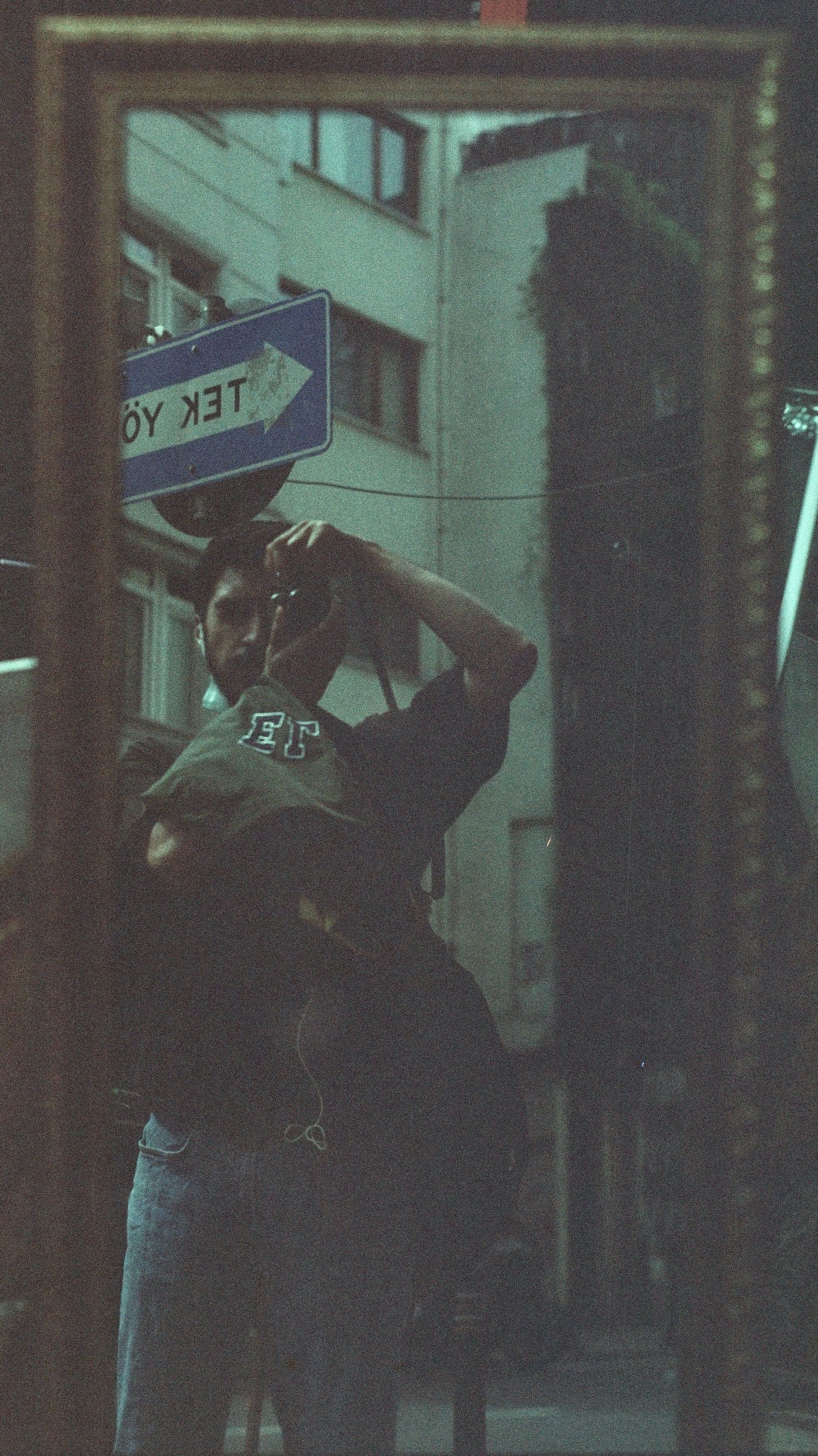 Urban reflection of a man capturing the city vibe in İstanbul.