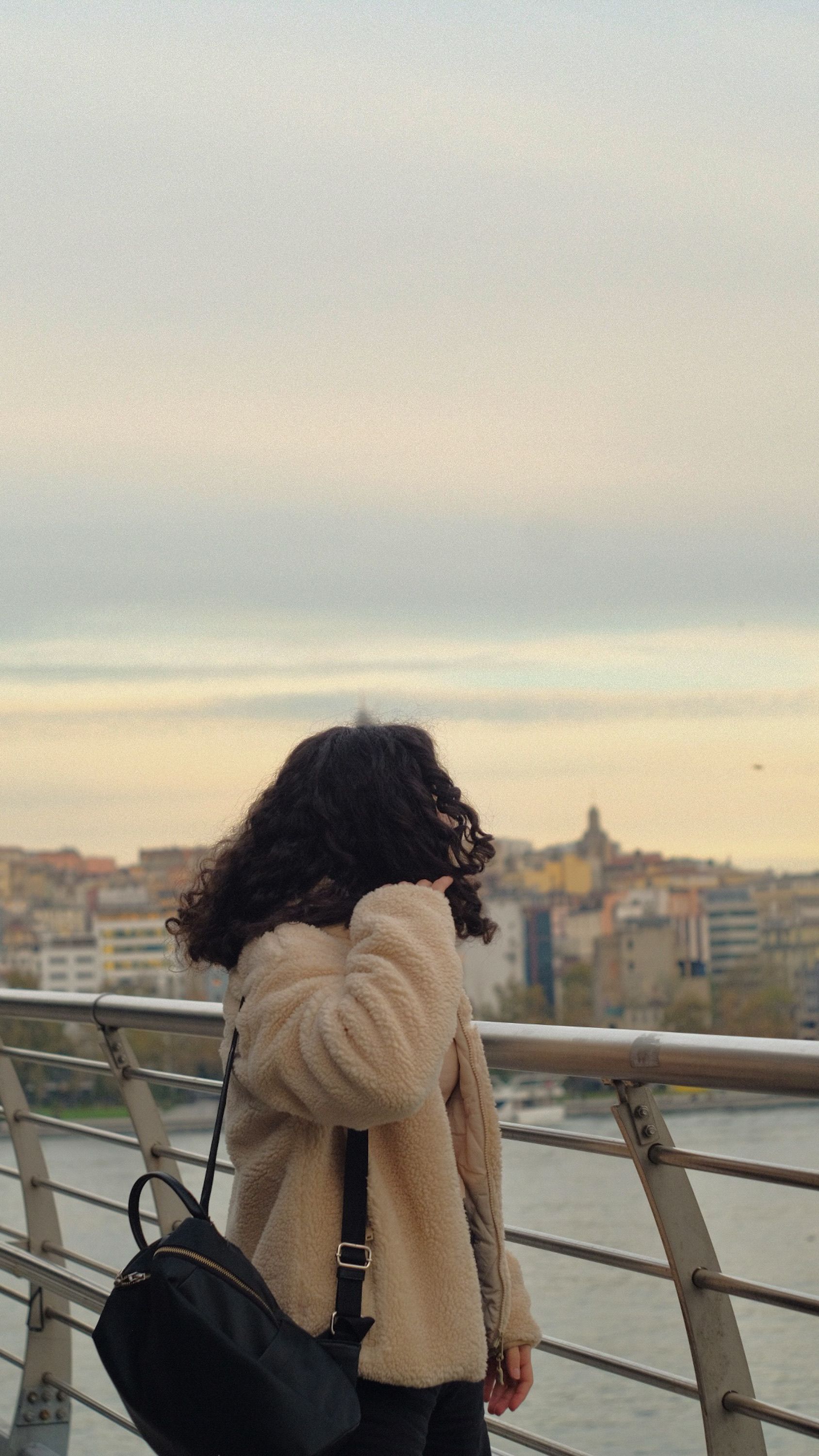 Woman Standing on a Bridge at Sunset · Free Stock Photo