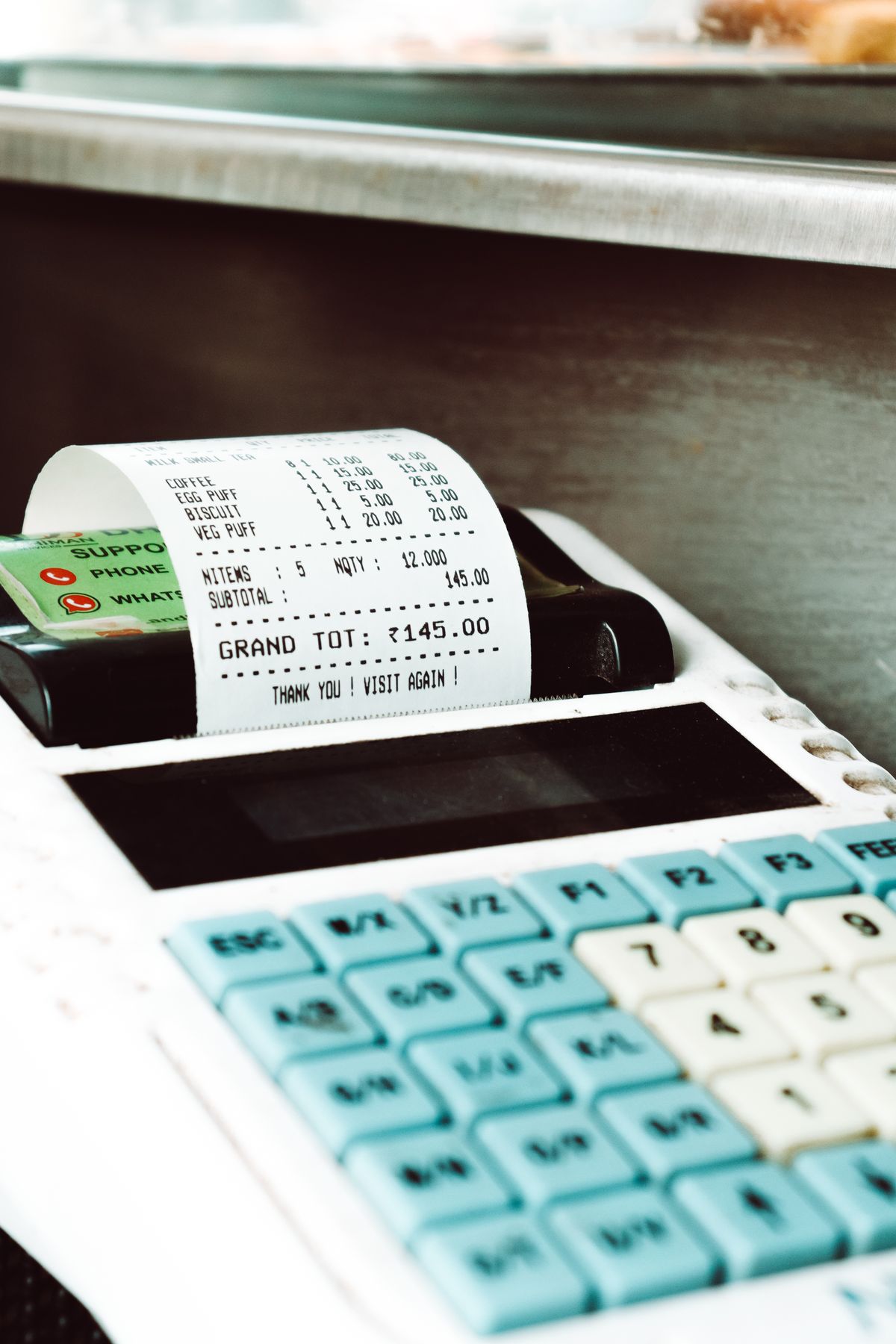 A till printing a receipt in a shop