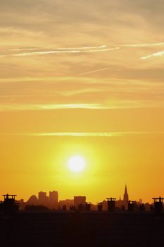 Stunning sunset over The Hague skyline, capturing the city's iconic silhouette against a vibrant golden sky.