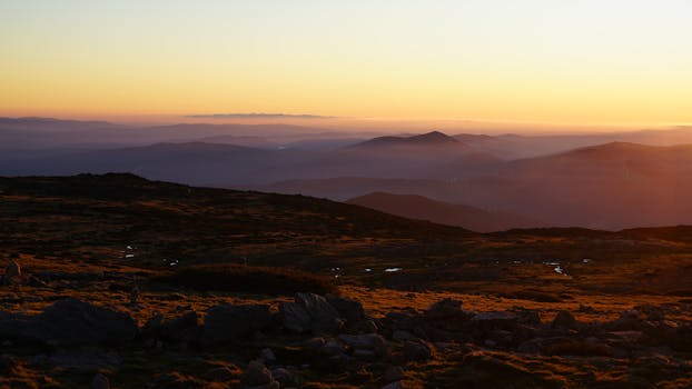 Peaceful sunrise view over rolling hills and mountains in Guarda, Portugal.