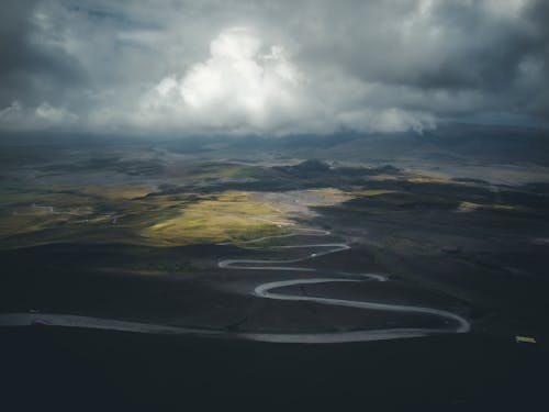 Aerial View of Mountains under a Cloudy Sky 