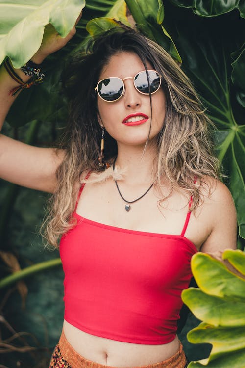 Woman Wearing Red Crop Top Holding Leaf