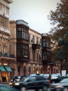 Scenic view of historic buildings and bustling streets in Baku, Azerbaijan at dusk.