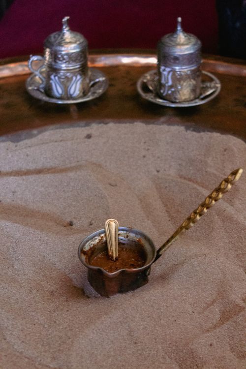 Free Authentic Turkish coffee brewed in sand with ornate cups in Şirince, Türkiye. Stock Photo