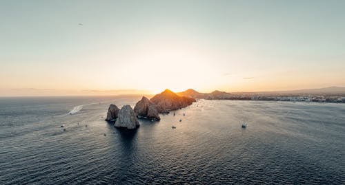 Sunset Sunlight over Rock Formations on Sea Coast